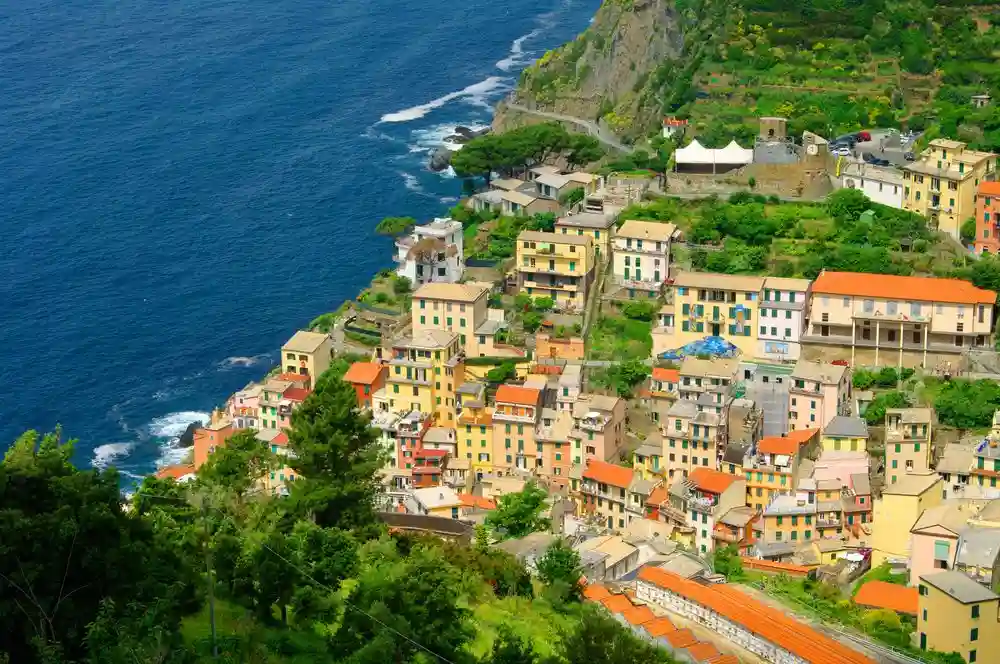 an aerial view of a village on the edge of a cliff